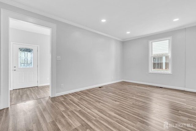 211 S Washington Ave, Dunellen, NJ 08812 - spare room featuring healthy amount of natural light, ornamental molding, wood finished floors, baseboards, and recessed lighting