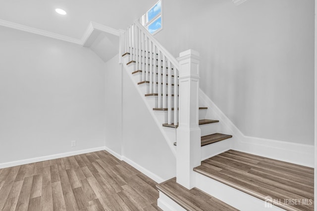 staircase with ornamental molding, wood finished floors, recessed lighting, and baseboards