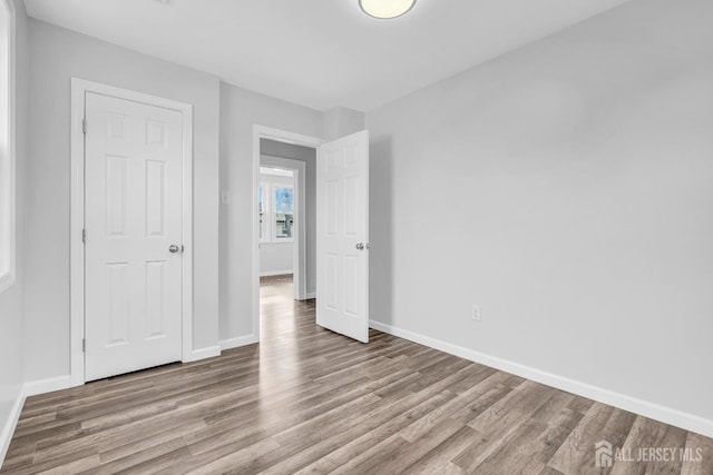 211 S Washington Ave, Dunellen, NJ 08812 - unfurnished bedroom with wood finished floors and baseboards