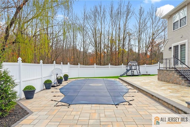 view of swimming pool with a patio area