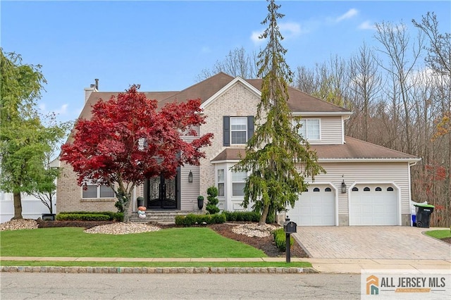 view of front of home with a garage and a front yard