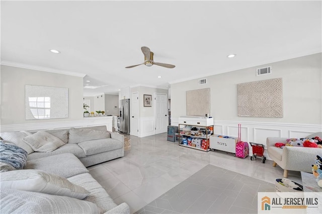 living room featuring ceiling fan and ornamental molding