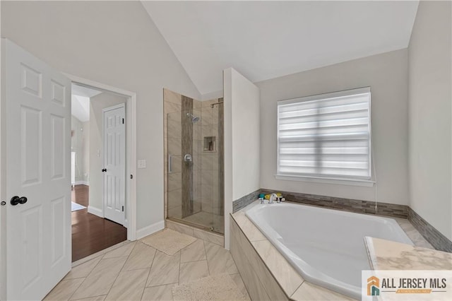 bathroom with shower with separate bathtub, lofted ceiling, and wood-type flooring