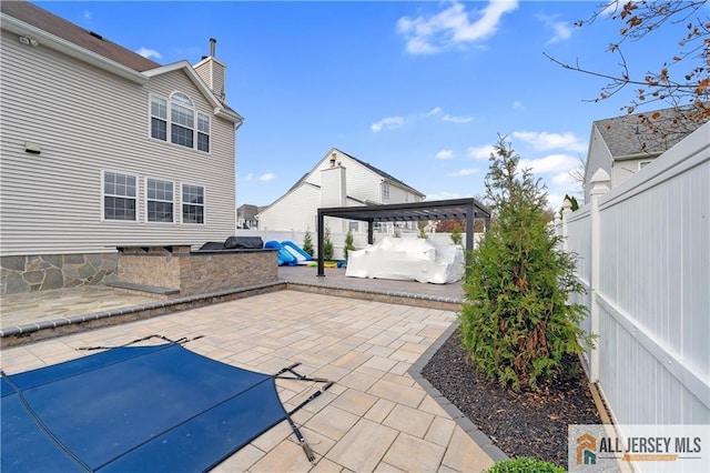 view of patio / terrace featuring an outdoor kitchen and a pergola