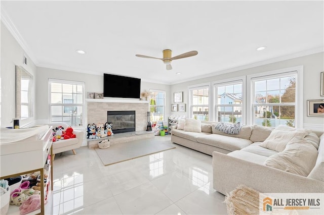 tiled living room featuring ceiling fan, crown molding, and a wealth of natural light