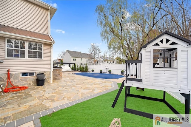 exterior space featuring a patio and a covered pool