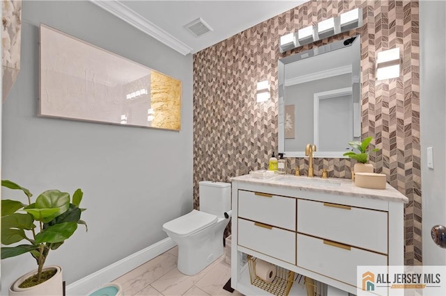 bathroom featuring crown molding, vanity, and toilet