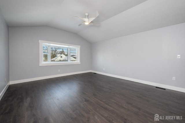 interior space with vaulted ceiling, dark hardwood / wood-style floors, and ceiling fan