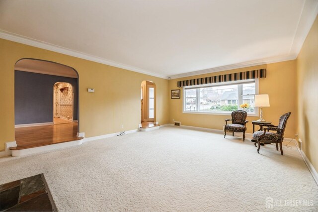 sitting room with carpet and ornamental molding