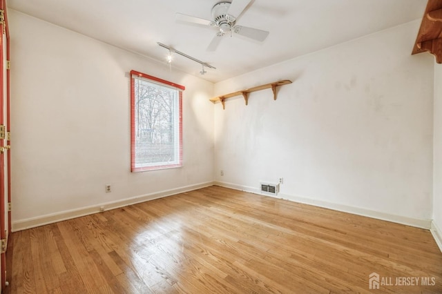 unfurnished room with light wood-type flooring, track lighting, and ceiling fan