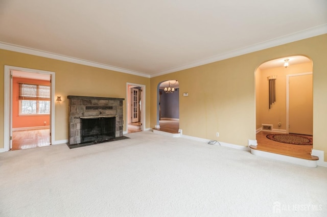 unfurnished living room featuring carpet flooring, a stone fireplace, and ornamental molding