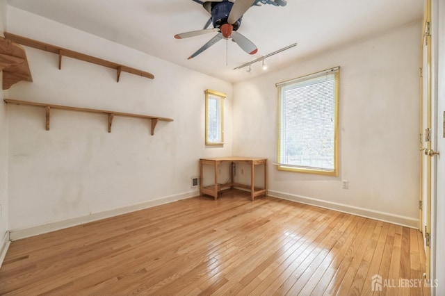 spare room with light hardwood / wood-style floors and ceiling fan