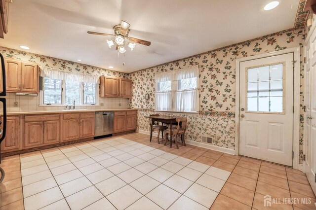 kitchen featuring dishwasher, ceiling fan, and light tile patterned flooring