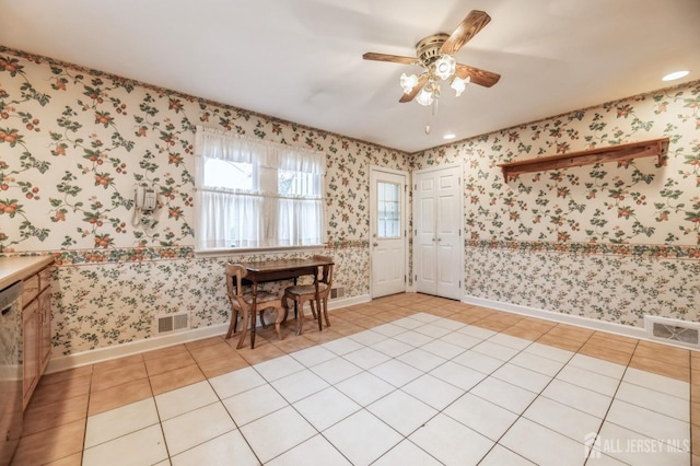 unfurnished dining area with ceiling fan and light tile patterned flooring