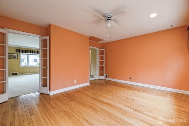 unfurnished room with french doors, light hardwood / wood-style floors, and ceiling fan