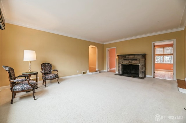 sitting room featuring crown molding, a fireplace, and carpet