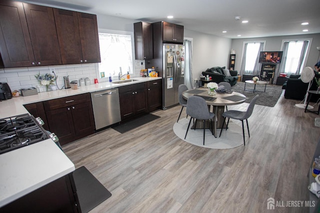 20 Prentice Ave, South River, NJ 08882 - kitchen featuring appliances with stainless steel finishes, plenty of natural light, open floor plan, dark brown cabinetry, and recessed lighting