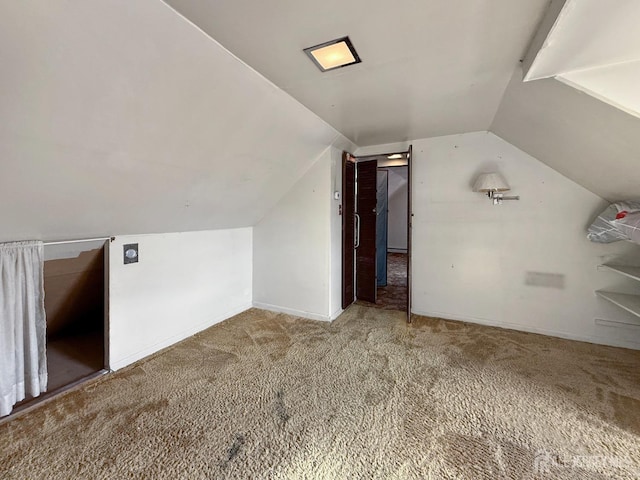 bonus room with vaulted ceiling, carpet flooring, and baseboards