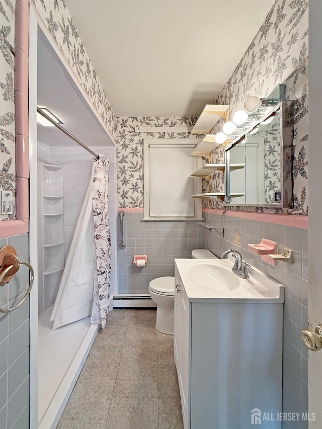 full bath featuring toilet, baseboard heating, a stall shower, wainscoting, and wallpapered walls