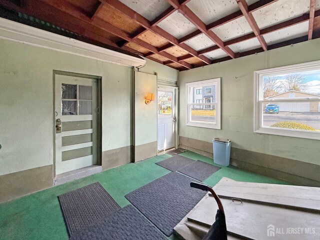 interior space featuring plenty of natural light and coffered ceiling