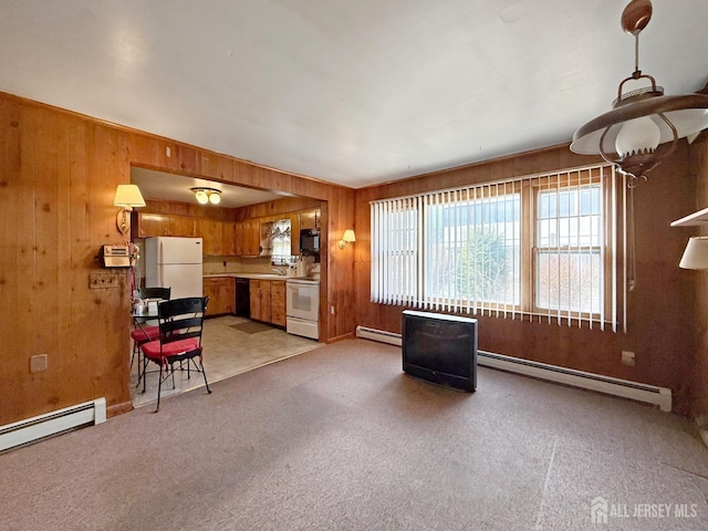 interior space with a baseboard heating unit, light carpet, and wooden walls