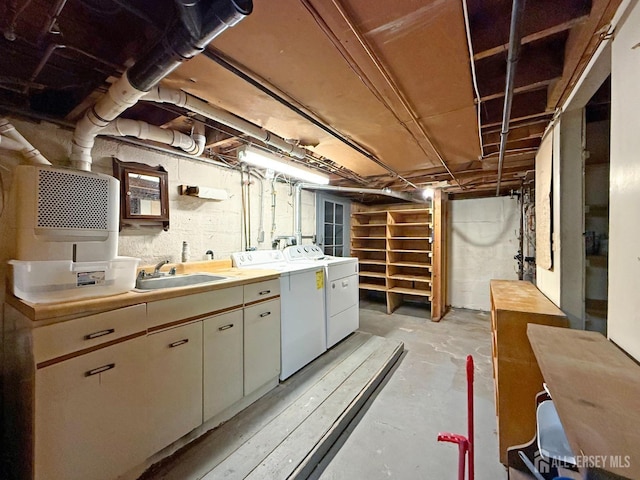 unfinished basement featuring independent washer and dryer and a sink