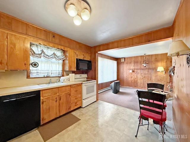 kitchen with wooden walls, light floors, light countertops, black appliances, and a sink