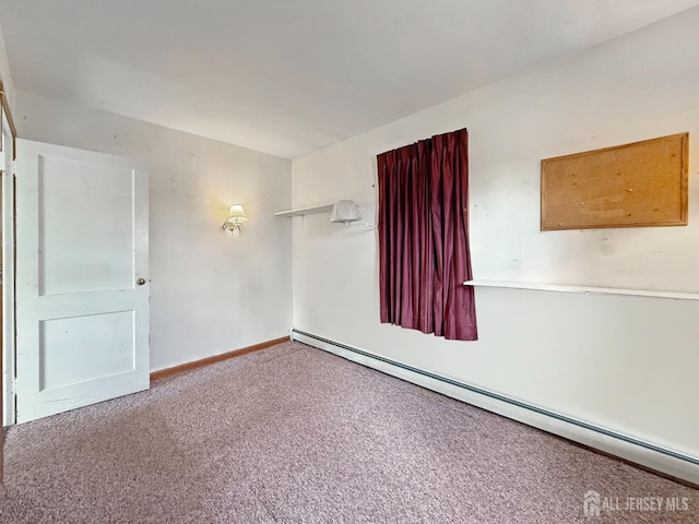 carpeted spare room with baseboards and baseboard heating