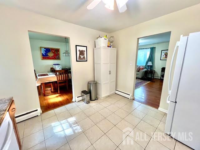 45 Browning Ave, Ewing, NJ 08638 - dining area featuring a baseboard radiator, light tile patterned floors, and a ceiling fan