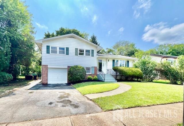 45 Browning Ave, Ewing, NJ 08638 - split level home featuring a garage, asphalt driveway, a front yard, and brick siding