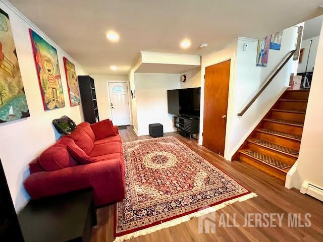 45 Browning Ave, Ewing, NJ 08638 - living room with wood finished floors, recessed lighting, stairway, and a baseboard radiator