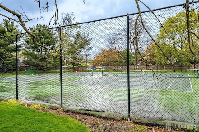 view of tennis court with fence