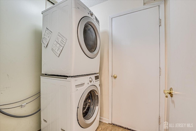 laundry area with laundry area and stacked washer and dryer