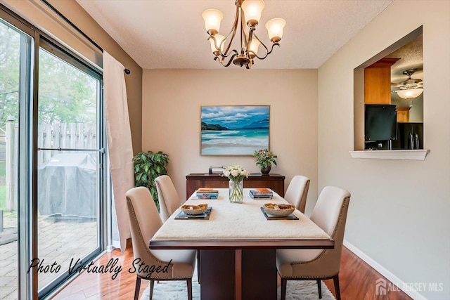dining space with baseboards, an inviting chandelier, and light wood-style floors