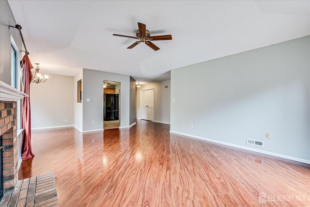13 Carriage Pl, Edison, NJ 08820 - unfurnished living room featuring a fireplace, ceiling fan, a chandelier, light wood-type flooring, and baseboards