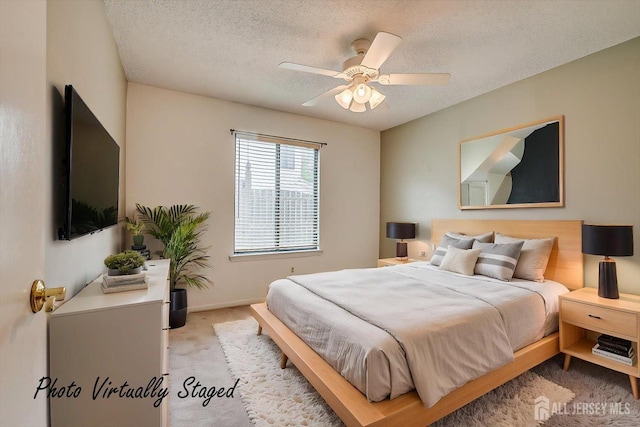 bedroom with baseboards, carpet flooring, a textured ceiling, and ceiling fan