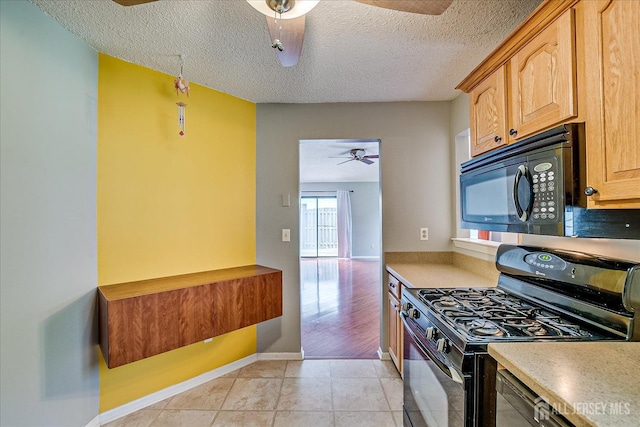 kitchen featuring ceiling fan, a textured ceiling, light countertops, baseboards, and black appliances