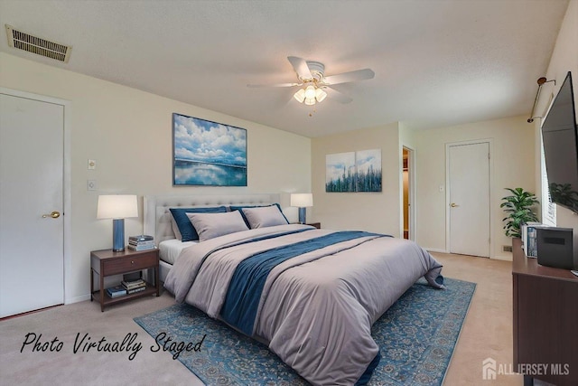bedroom with ceiling fan, visible vents, light carpet, and baseboards