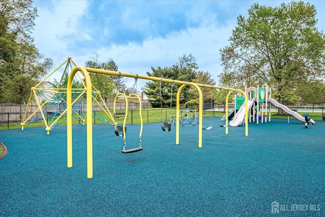 community jungle gym featuring fence