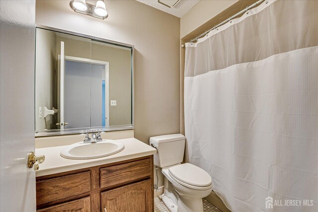 full bathroom featuring vanity, tile patterned floors, toilet, and a shower with shower curtain