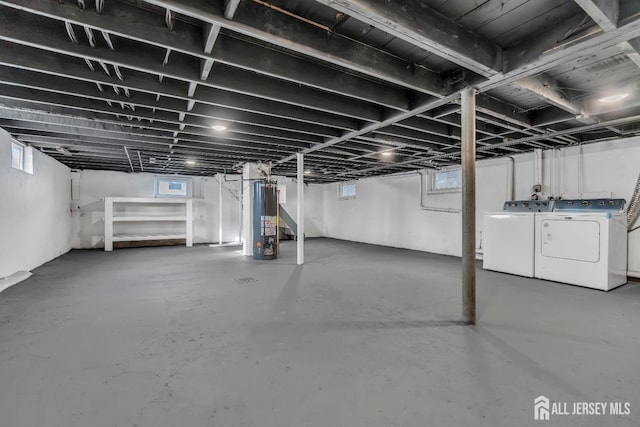 below grade area with water heater and washing machine and clothes dryer