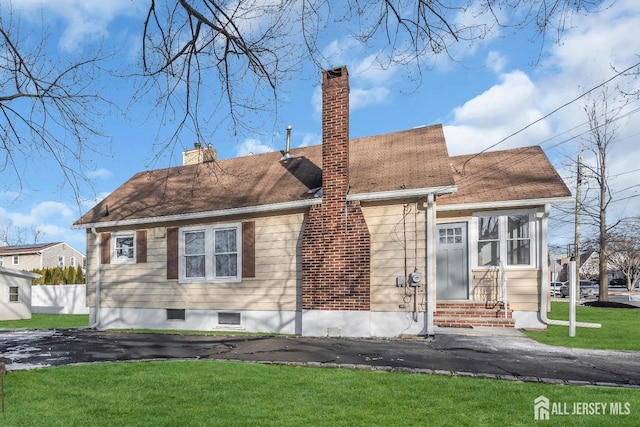 221 E Golf Ave, South Plainfield, NJ 07080 - view of front of home with entry steps, a front lawn, and a chimney