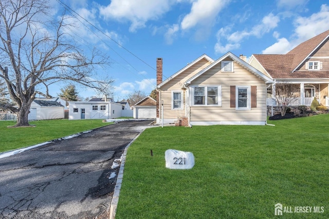 221 E Golf Ave, South Plainfield, NJ 07080 - view of front of property with an outbuilding, a front lawn, a chimney, and a garage