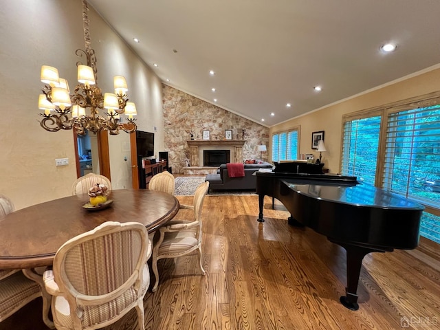 2 Gloucester Ct, East Brunswick, NJ 08816 - dining area with vaulted ceiling, a chandelier, wood finished floors, and a high end fireplace