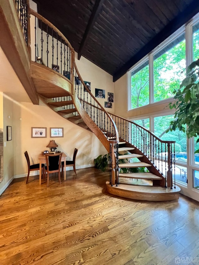 2 Gloucester Ct, East Brunswick, NJ 08816 - stairway with a healthy amount of sunlight, hardwood / wood-style floors, and high vaulted ceiling