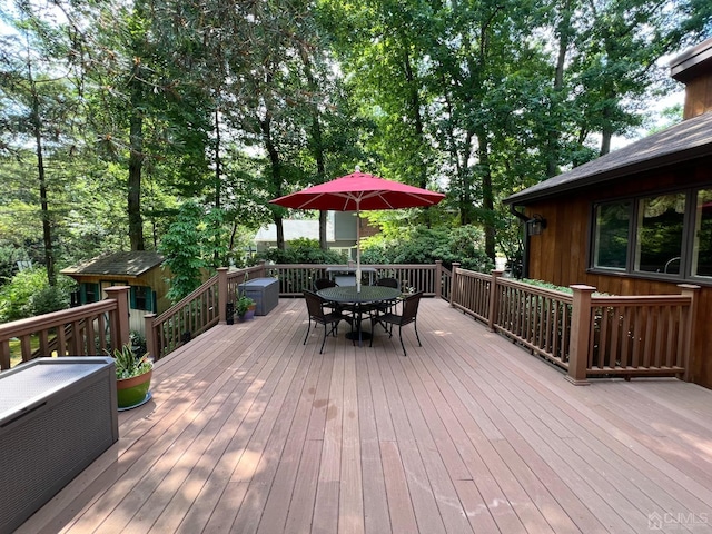 2 Gloucester Ct, East Brunswick, NJ 08816 - wooden terrace featuring an outdoor structure, outdoor dining space, and a storage shed