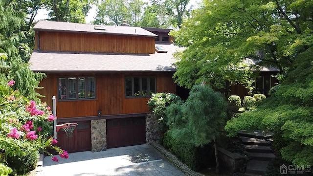 2 Gloucester Ct, East Brunswick, NJ 08816 - view of front facade featuring roof with shingles, concrete driveway, a garage, and stone siding