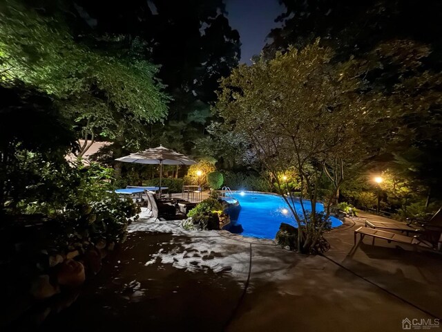 2 Gloucester Ct, East Brunswick, NJ 08816 - pool at night with a patio and an outdoor pool