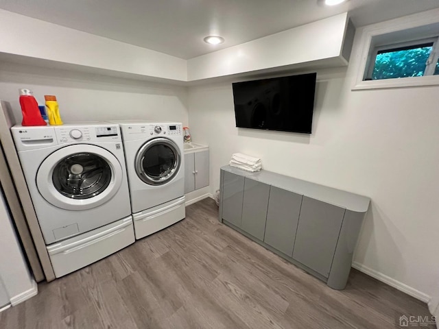 2 Gloucester Ct, East Brunswick, NJ 08816 - laundry room featuring washing machine and dryer, cabinet space, baseboards, and light wood-type flooring