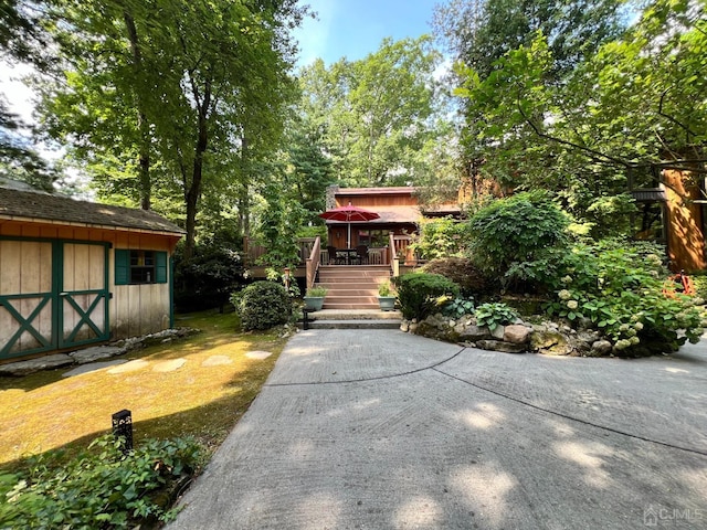 2 Gloucester Ct, East Brunswick, NJ 08816 - view of front of property with an outdoor structure, a deck, and a storage unit